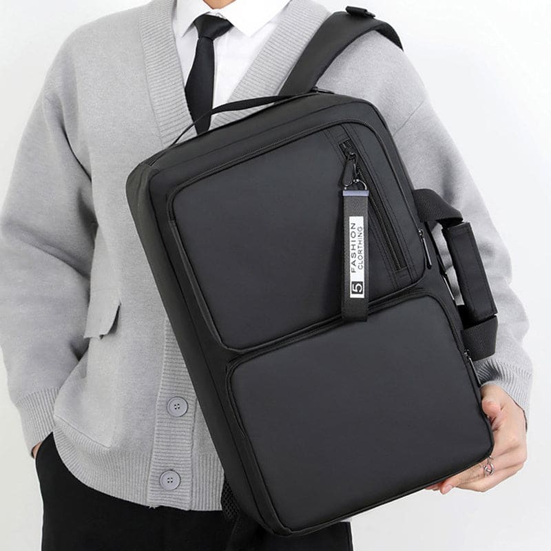 Black rectangular backpack with multiple compartments and a shoulder strap.