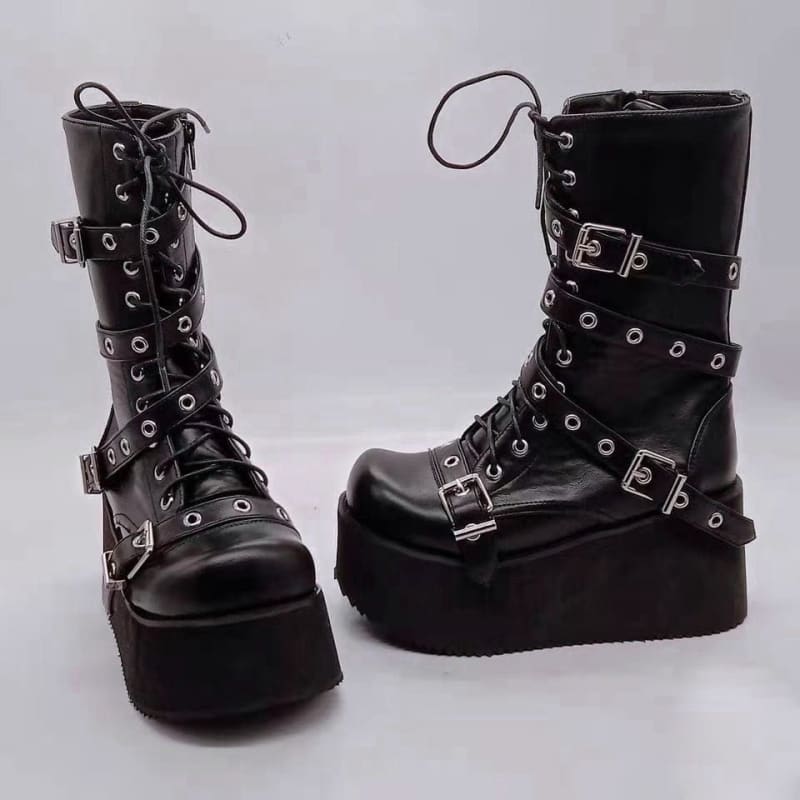 Pair of black leather platform boots with buckles, laces, and metal eyelets.