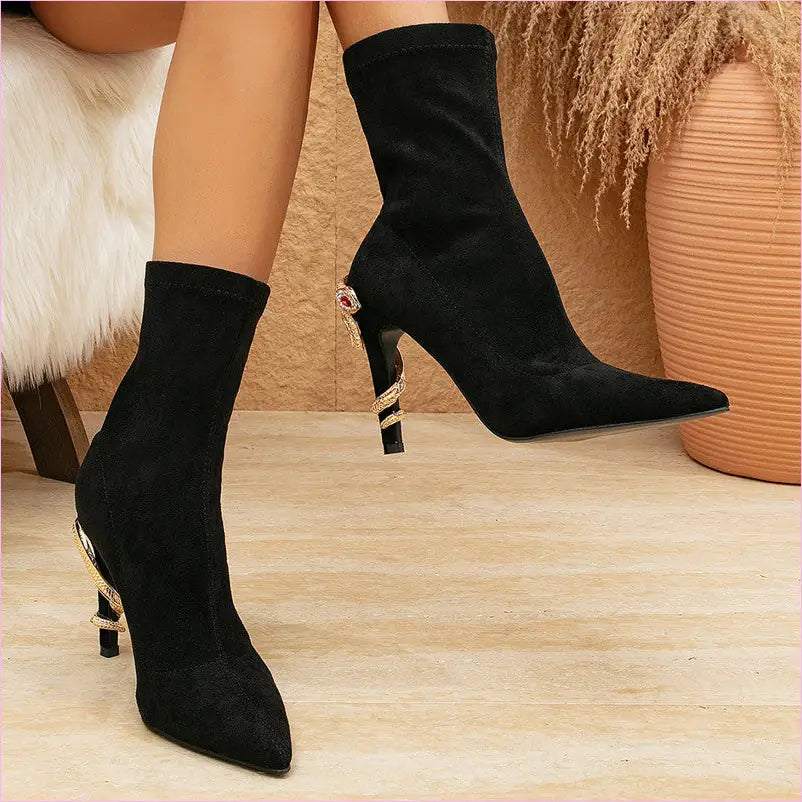 Pair of black pointed-toe ankle boots with striped heels.