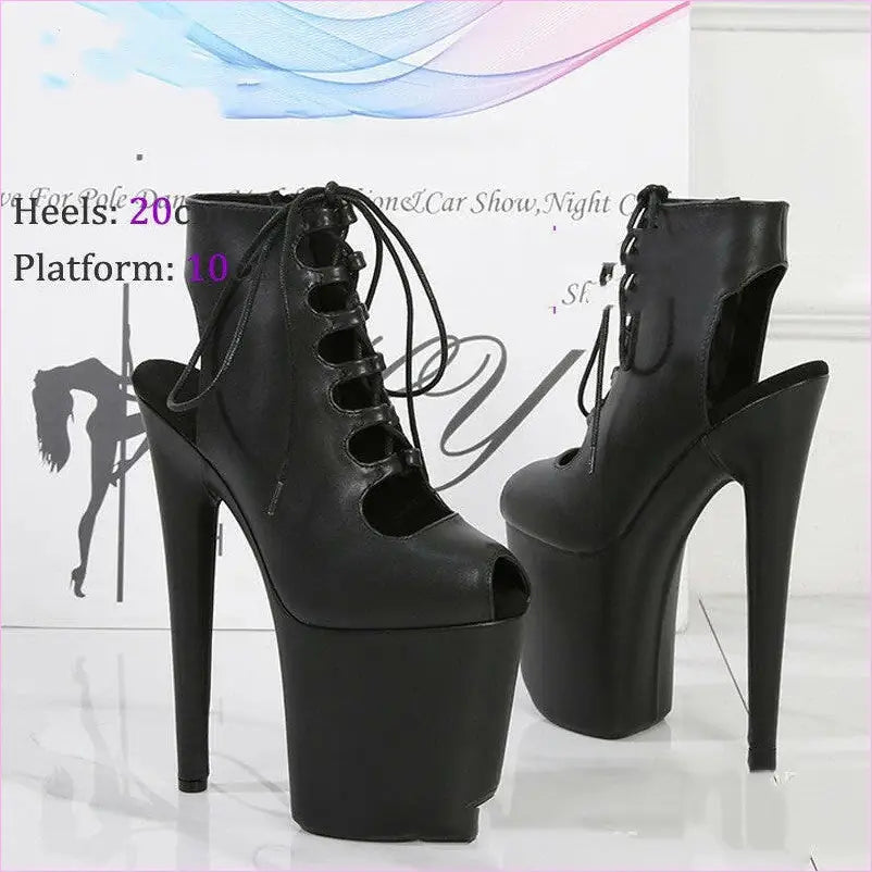 Pair of extremely high-heeled black platform boots with lace-up fronts and open heels.