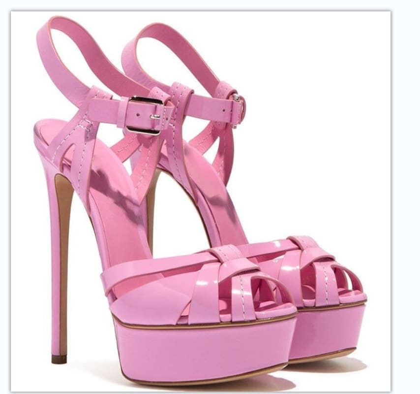 Pink high-heeled platform sandal with strappy design and ankle strap.