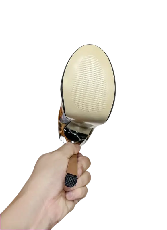 Hand-held magnifying glass with a round lens and metal handle.