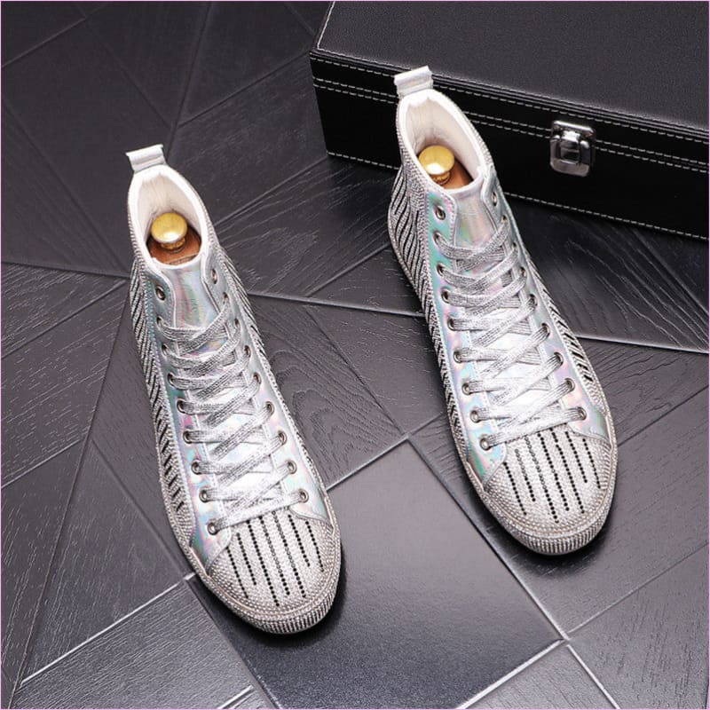 Pair of silver high-top sneakers with perforated design and white laces.