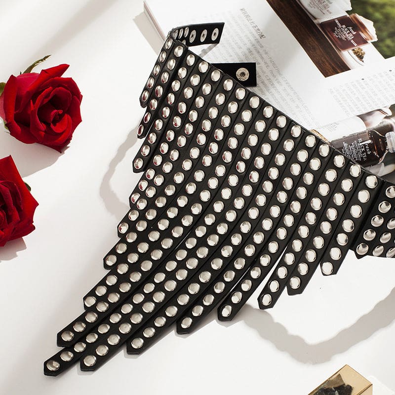 Polka dot fabric cut into a triangular or wing-like shape.