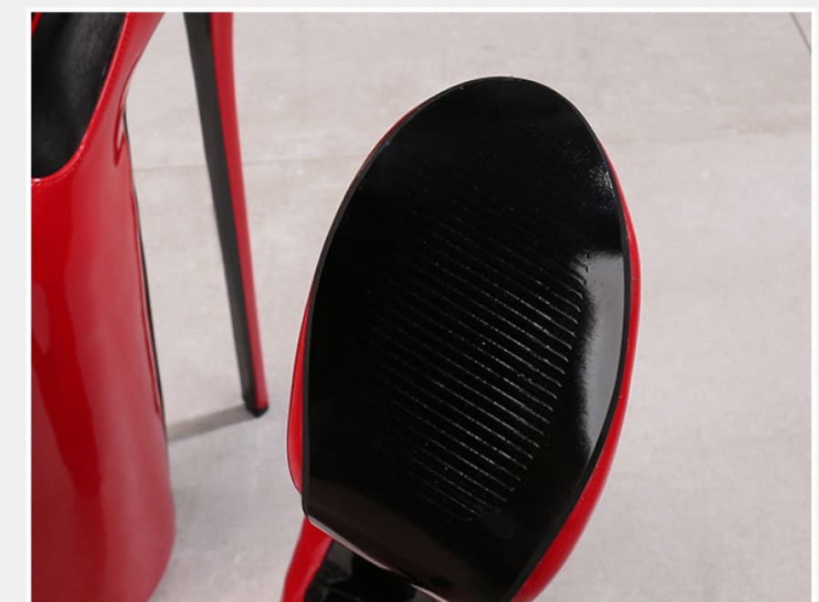 Red high-heeled shoe with a black sole and stiletto heel.