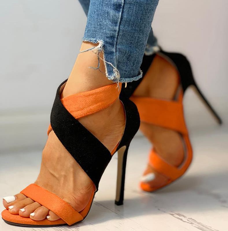 Stylish high-heeled sandals with orange and black straps.