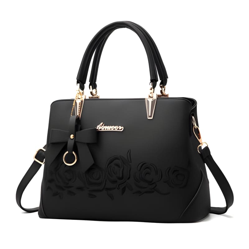 Black leather handbag with gold-tone hardware and embossed floral design.