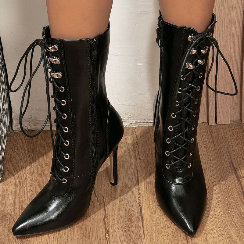 Pair of black high-heeled lace-up ankle boots with pointed toes.