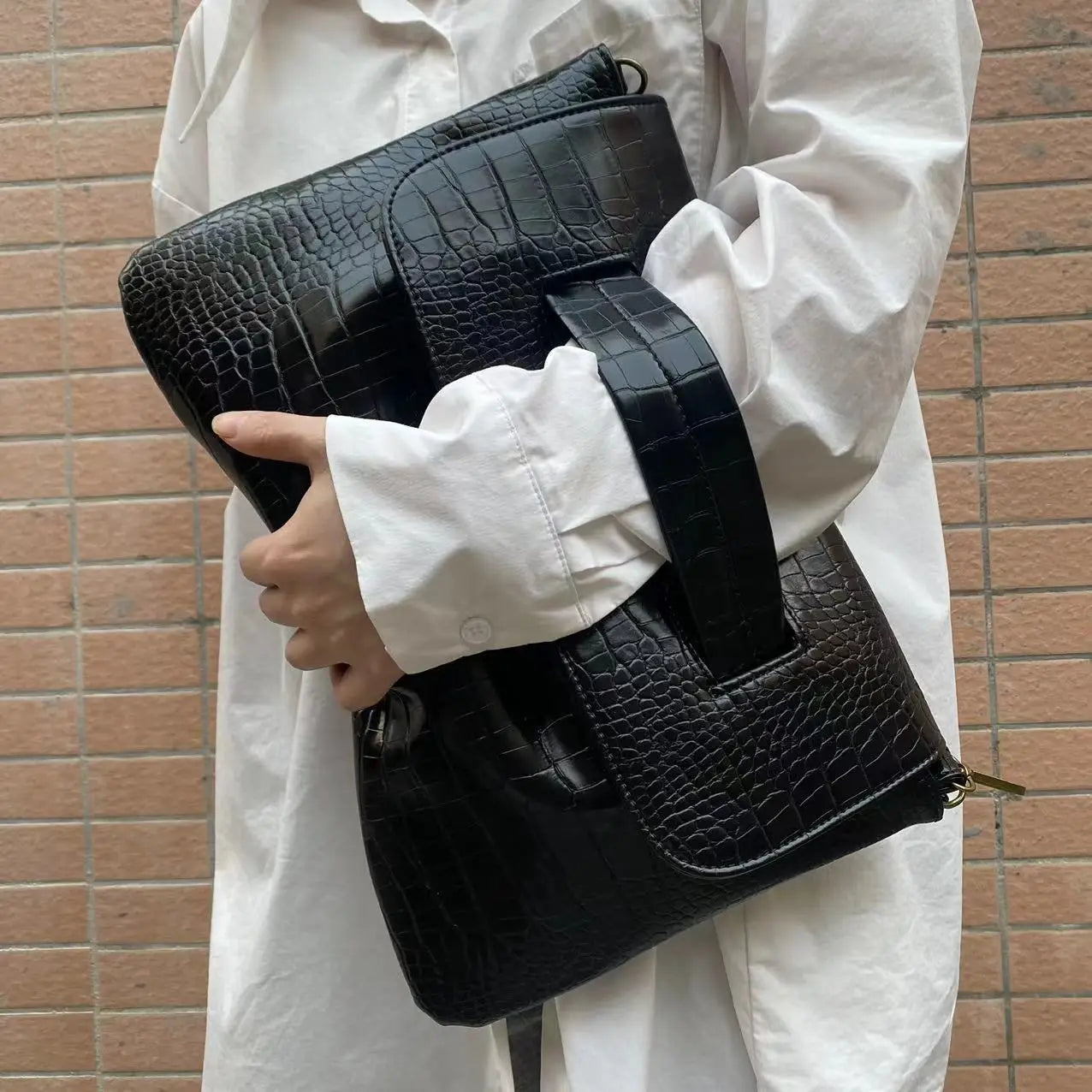 Black crocodile pattern bag with wide strap, perfect as a sleeve document bag.