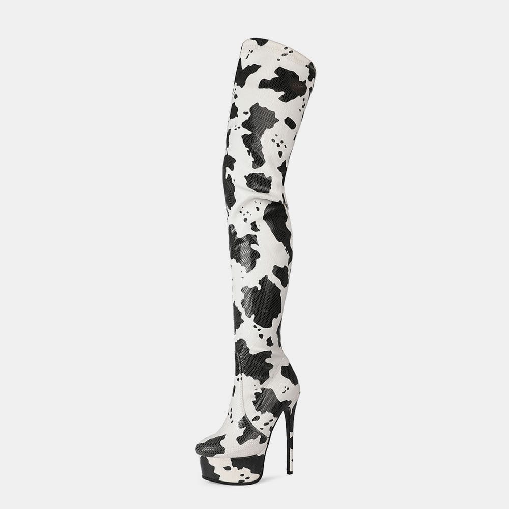 Thigh length platform boots with trendy black and white cow print for standout style.