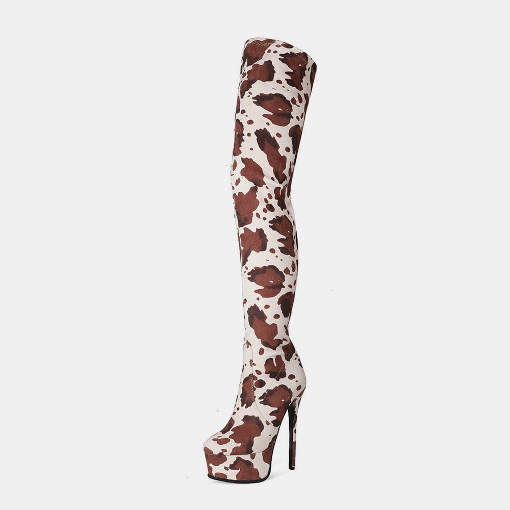 Thigh length platform boots featuring a trendy brown and white cow print pattern.