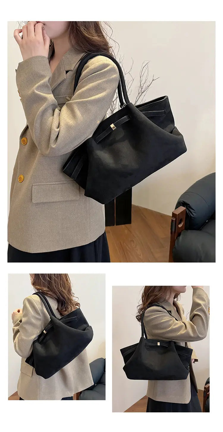 Black leather handbag with structured shape and double handles for modern women.