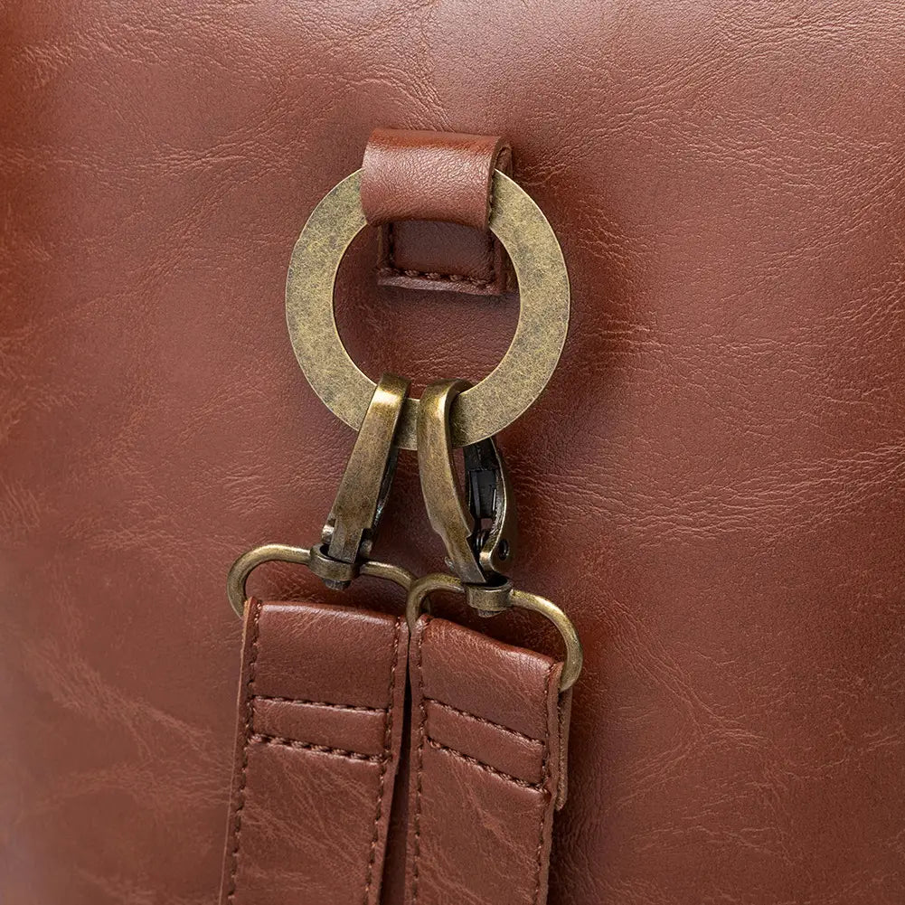 Brass ring hardware on brown leather straps for a Steampunk Retro Shoulder Bag.