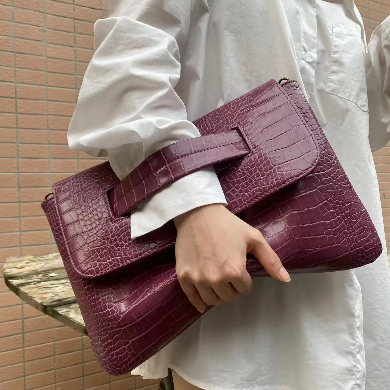 Burgundy crocodile pattern bag with a wide flap, perfect as a sleeve document bag.