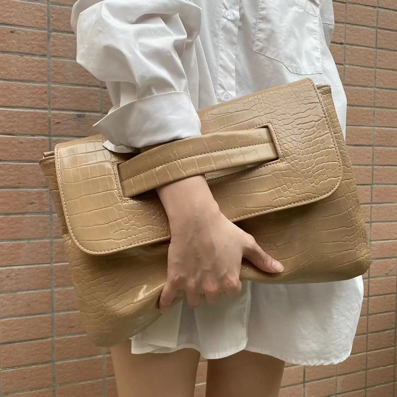 Beige crocodile pattern bag with top handle, perfect as a sleeve document bag.