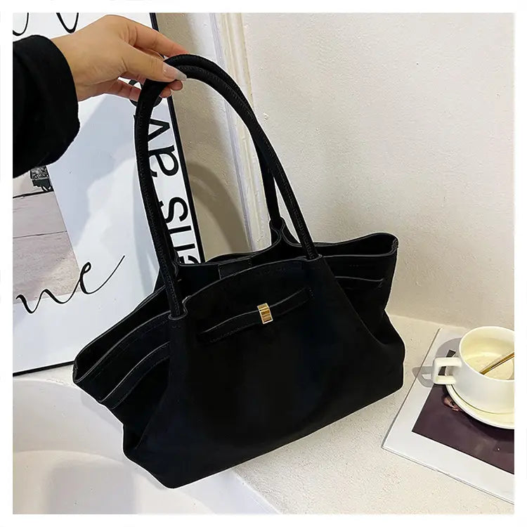 Elegant suede tote bag in black, featuring a structured shape and double handles.