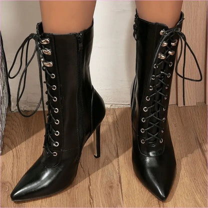Pair of black high-heeled lace-up ankle boots with pointed toes.