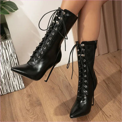 Pair of black high-heeled lace-up boots with pointed toes and stiletto heels.