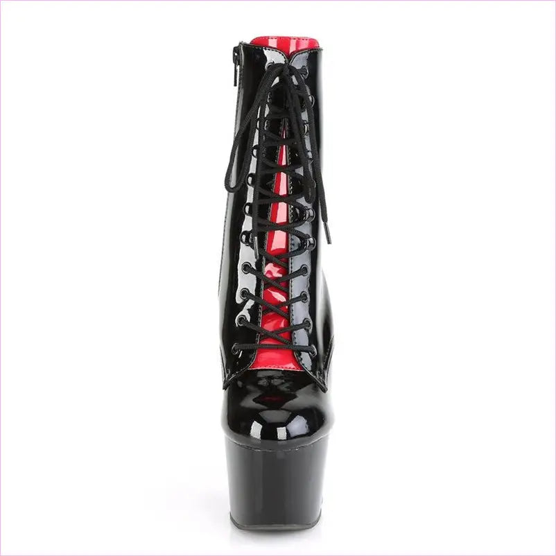 Black patent leather platform ankle boot with red interior and lace-up front.