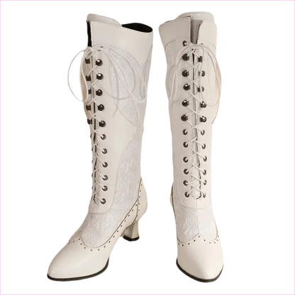 Pair of white knee-high lace-up boots with pointed toes and heels.