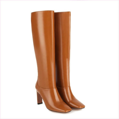 Pair of tall, tan leather boots with high heels.