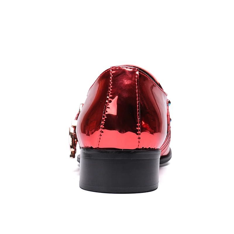 Metallic red dress shoe with buckle and black sole, a stylish leather men’s pointed option.