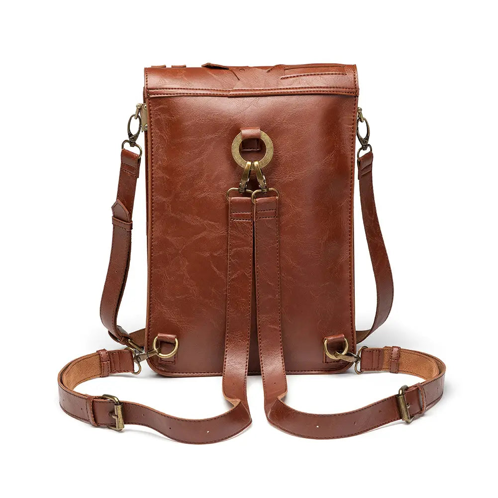 Brown leather convertible shoulder bag with unique embossing and adjustable straps.