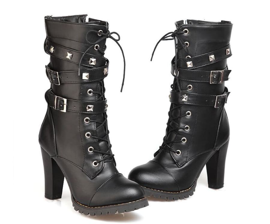 Pair of black high-heeled combat boots with buckles and studs.