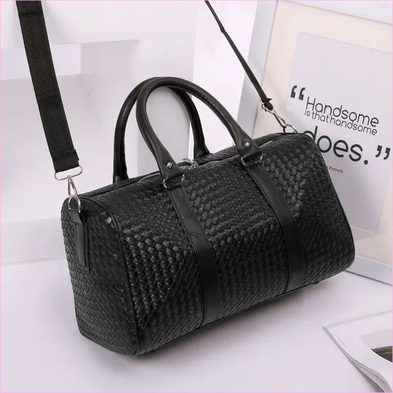 Black woven leather duffle bag with handles and a shoulder strap.