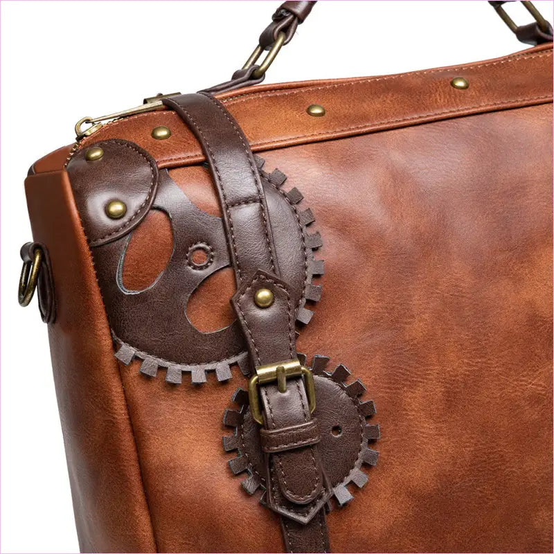 Brown leather briefcase with decorative gear-shaped embellishments and brass hardware.